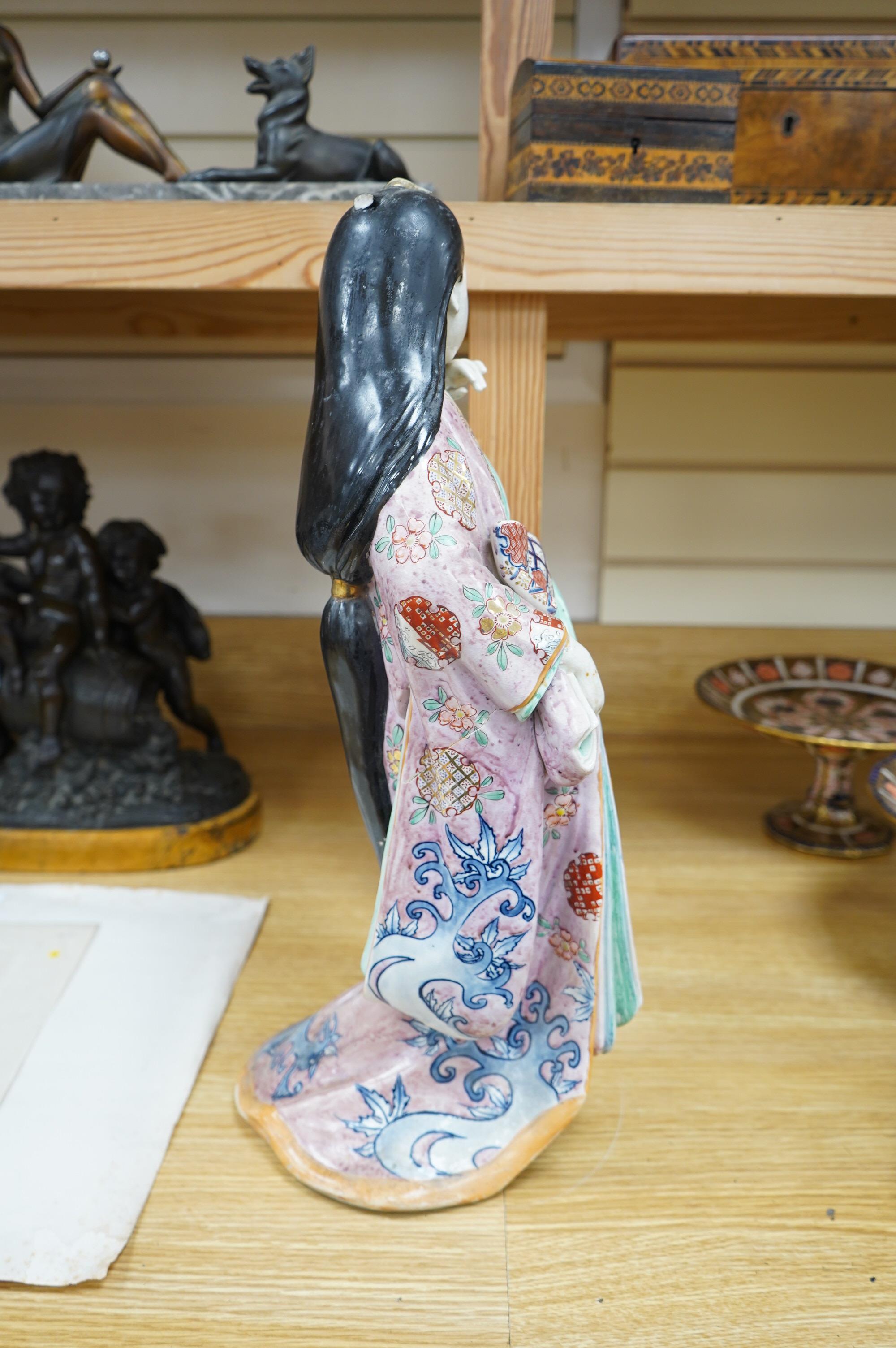 A Japanese earthenware figure of a lady, circa 1900, 46cm. Condition - poor